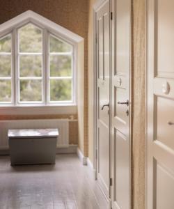 an empty room with a door and a window at Tammiston Bed&Breakfast in Naantali