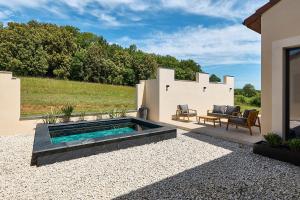 a swimming pool in the middle of a yard at Secluded Pool Villa near Castle in Beynac-et-Cazenac