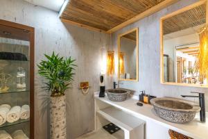 a bathroom with two sinks and a mirror at Villa Zoi in Sissi +47 photos