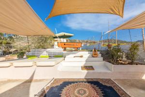 a patio with white furniture and umbrellas at Villa Zoi in Sissi