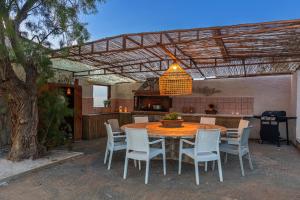 a wooden table and chairs in a patio at Villa Zoi in Sissi