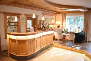 a kitchen with a bar and a living room at Gartenhotel Kloepferkeller in Eibiswald