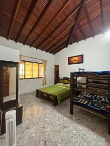 a bedroom with two bunk beds and a fireplace at Finca Las Palmas San Gil in San Gil