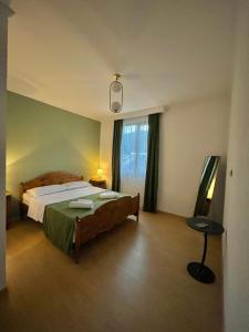 a bedroom with a large bed and a window at Cozy-Corner Guesthouse in Mestia