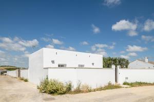 a white building on the side of a road at Casa Sol in Conil de la Frontera