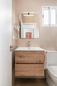 a bathroom with a sink and a mirror at Casa Sol in Conil de la Frontera