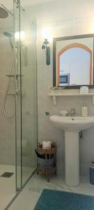 a bathroom with a shower and a sink and a mirror at Apartments Sara in Bale +64 photos