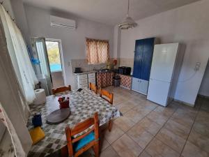 a kitchen with a table and a refrigerator at DianaHub in Artemida