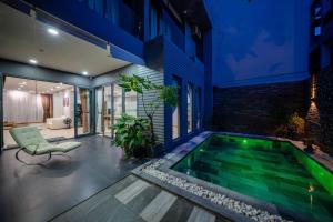 a swimming pool in the middle of a house at Sila Anila 7BRs Pool Villa My Khe Beach Da Nang in Da Nang