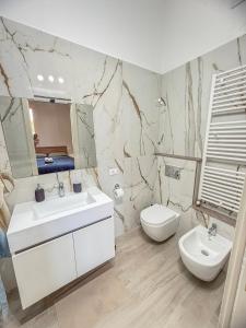 a white bathroom with a sink and a toilet at Villa Miky - Via Francigena Altopascio in Orentano +34 photos
