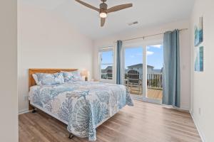 a bedroom with a bed and a balcony at Chipps Ahoy in Oak Island