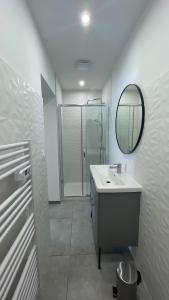 a white bathroom with a sink and a mirror at Résidence San Paolisa in Hyères +139 photos