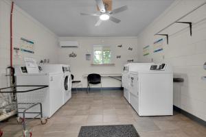 a laundry room with a washer and dryer at Charming Cabin with Parking in Pigeon Forge