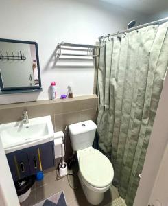 a bathroom with a toilet and a sink at Stellars Place in Bacolod
