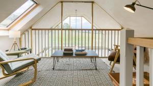 a living room with a table and a window at Bwthyn Ysgubor in Conwy