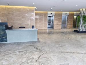 an office lobby with a reception desk and marble walls at Mziuri Gardens, Block A, 719 in Batumi