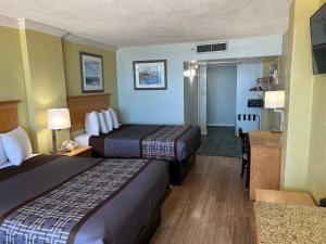 a hotel room with two beds and a kitchen at Seahawk Motel in Virginia Beach +9 photos