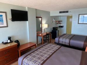 a hotel room with a bed and a desk at Seahawk Motel in Virginia Beach