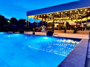 a swimming pool in front of a building at night at Drive Point (Adventure Lake Resort) in Asparukhovo