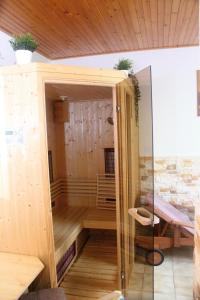 a sauna with a glass door in a room at Penzion Ján in Habovka