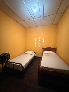 Postel nebo postele na pokoji v ubytování Buena Onda House + 14 fotografií