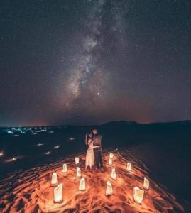 メルズーガにあるBerber Luxury Campの二人の夫婦が星空の下に立っている