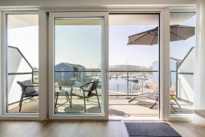 a room with sliding glass doors with a view of a marina at Apartment Havenzicht 8a Kortgene in Kortgene