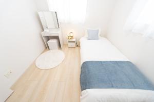 a small bedroom with two beds and a mirror at Miraie Suzuka Shimomida in Suzuka +36 photos