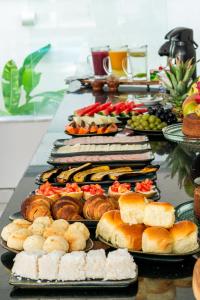 un buffet con molti tipi di pane e dolci di Pousada Corais de Ibiza a Arraial d'Ajuda