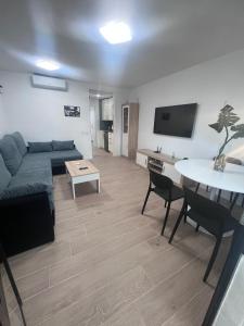 a living room with a couch and a table at Can Paquito Fuerteventura in Corralejo
