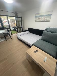 a room with a bed and a couch and a table at Can Paquito Fuerteventura in Corralejo