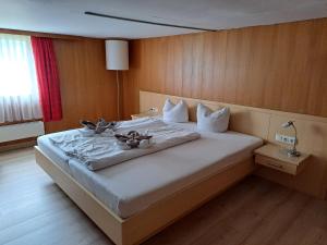 a bedroom with a large bed with flowers on it at Familienfreundliches Bregenzerwälderhaus in Au im Bregenzerwald