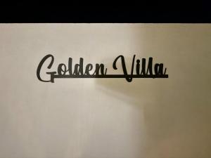 a sign that reads garden village on a wall at GOLDEN VILLA by Stay in Alentejo in Vila Nova de Milfontes