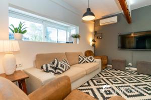 a living room with a couch and a tv at Beautiful Villa Encanto with private pool in Olivella