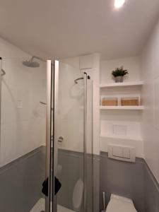 a bathroom with a glass shower and a toilet at Studio Sopot Twins in Sopot +61 photos