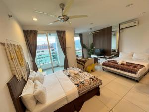 a bedroom with two beds and a living room at Georgetown Mansion One Apartment by Jere Penang Gleneagles Gurney in George Town