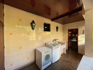 a laundry room with a washing machine and a sink at Casa 02 Mansão Bardo 2 qts Piscina Petrópolis RJ - Venha para Baurnfest in Petrópolis