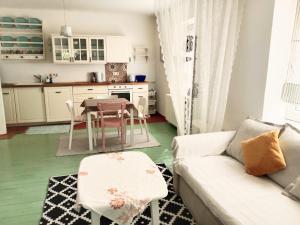 a living room with a couch and a table at Millstream Apartment in Sankt Veit an der Glan