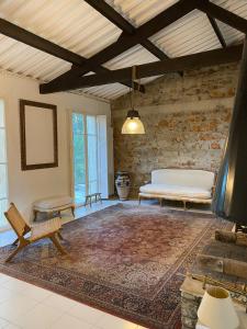 a bedroom with a bed and a bench and a rug at Villa Claudia Domaine les Palmiers in Pignans +111 photos