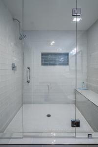 a shower with a glass door in a bathroom at Modern 2BR Retreat Near Emory & Downtown ATL in Atlanta
