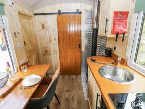 a tiny house with a sink and a table at The Hamper in Carmarthen