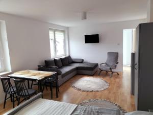a living room with a couch and a table at Pokoje u Bożeny in Ostrowo