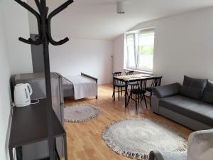 a living room with a couch and a table at Pokoje u Bożeny in Ostrowo
