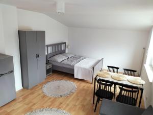 a bedroom with a bed and a table with chairs at Pokoje u Bożeny in Ostrowo