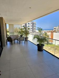 a balcony with plants and a view of the ocean at Villa M Panoramic Seaview Almadies in Dakar