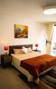a bedroom with a bed and a painting on the wall at Villa M Panoramic Seaview Almadies in Dakar