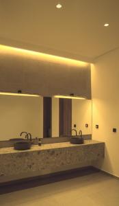a bathroom with two sinks and a large mirror at Villa M Panoramic Seaview Almadies in Dakar