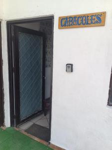 a door to a building with a sign on it at Habitaciones Comodas in Manzanillo