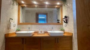 a bathroom with two sinks and a large mirror at Nicole Residence in Las Terrenas +19 photos