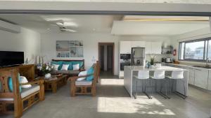 a kitchen and a living room with a kitchen and a living room at Nicole Residence in Las Terrenas